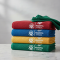 Stack of colorful Presidential-branded microfiber towels on marble counter